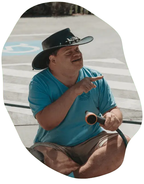 person with disability in a blue shirt wearing a hat