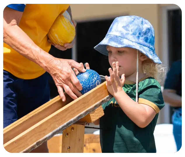 Child following verbal directions learning a new skills - bowling