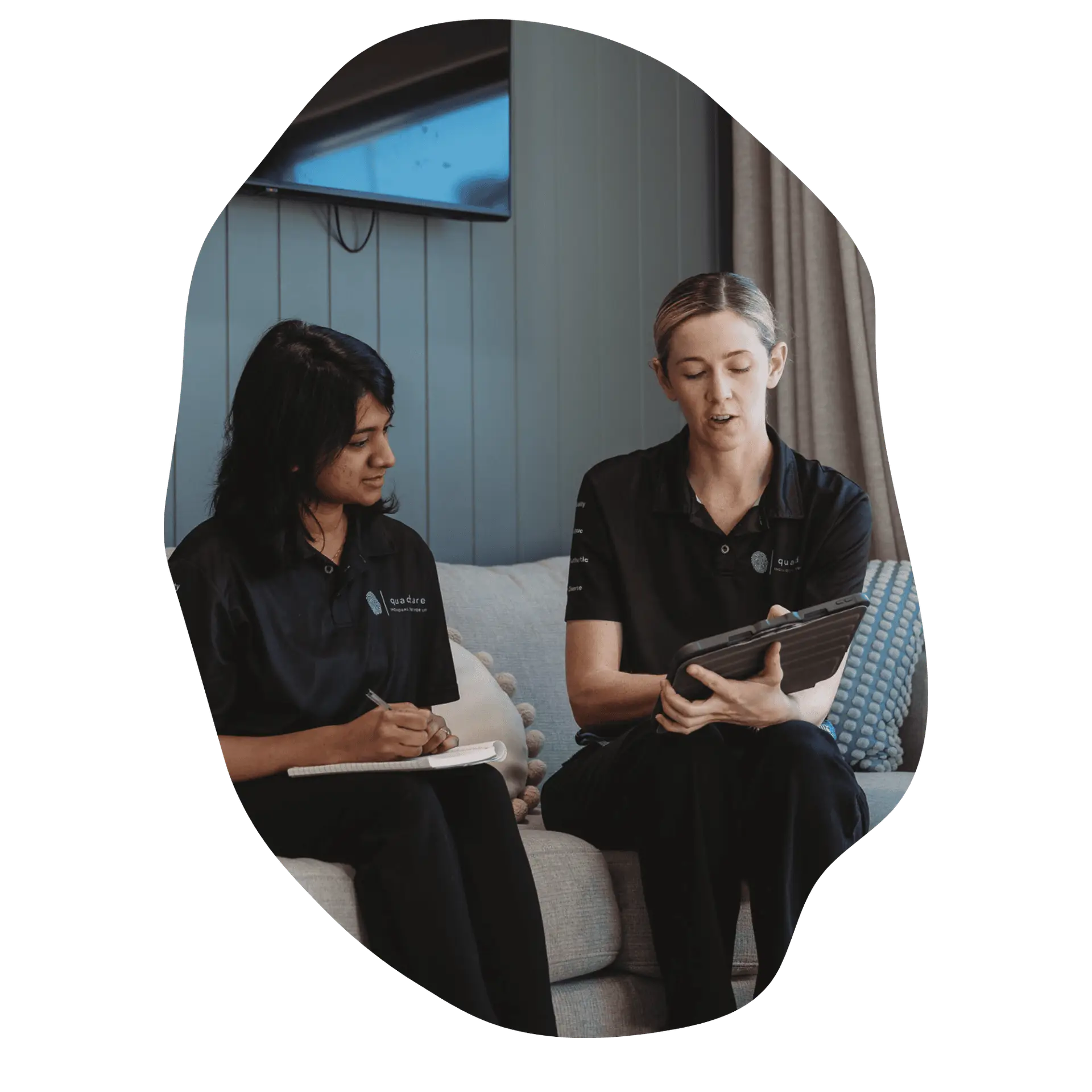 Two occupational therapists discussing participant goals and therapy planning.